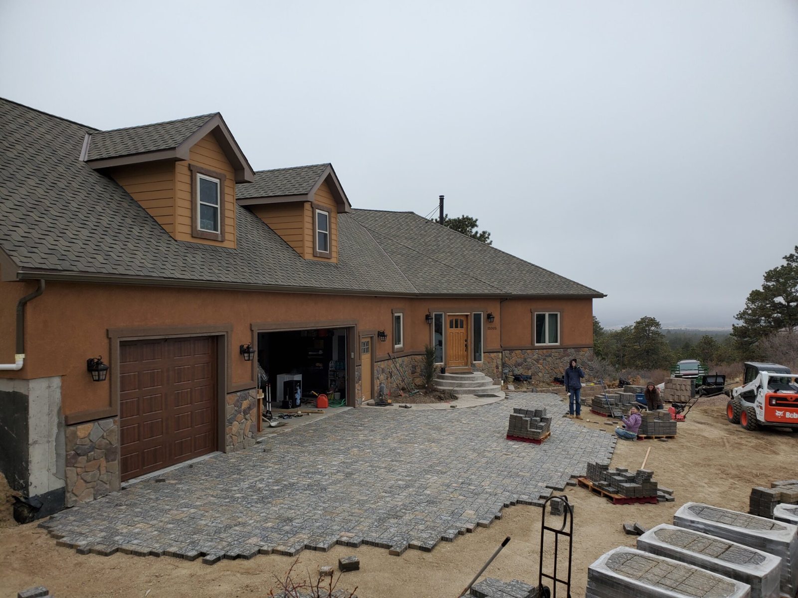 The Gilliland family laying the paver driveway at their home